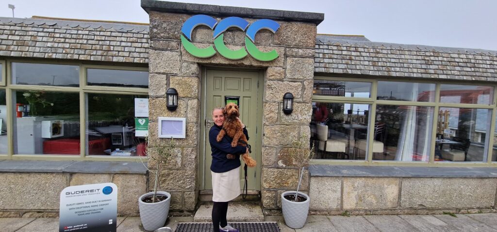 Owner and dog at entrance to Cape Cornwall Club St Just